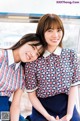 A couple of young women sitting next to each other.